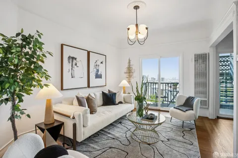 a living room with furniture potted plant and window