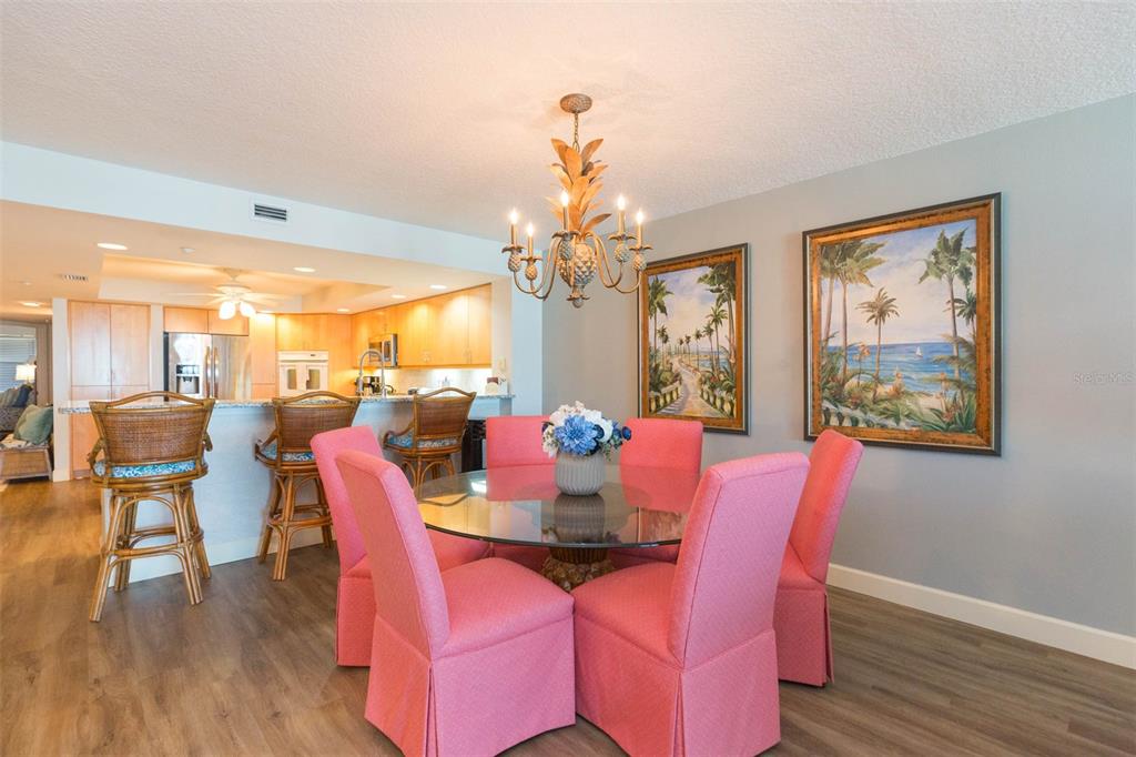 16326 Gulf Boulevard, Unit 109 Redington Beach, FL 33708 - Photo 13 of 63 a dining room with furniture a large window and wooden floor