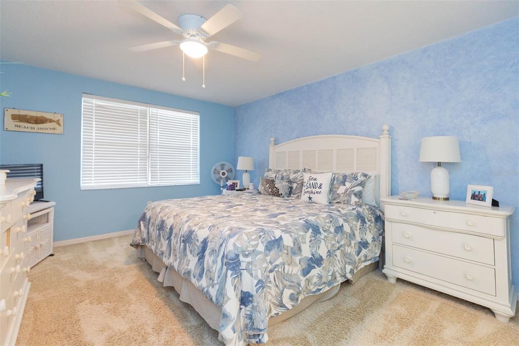 16326 Gulf Boulevard, Unit 109 Redington Beach, FL 33708 - Photo 19 of 63 a bedroom with a bed and a chandelier