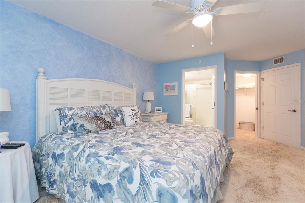 16326 Gulf Boulevard, Unit 109 Redington Beach, FL 33708 - Photo 20 of 63 a large bed sitting in a bedroom and a chandelier