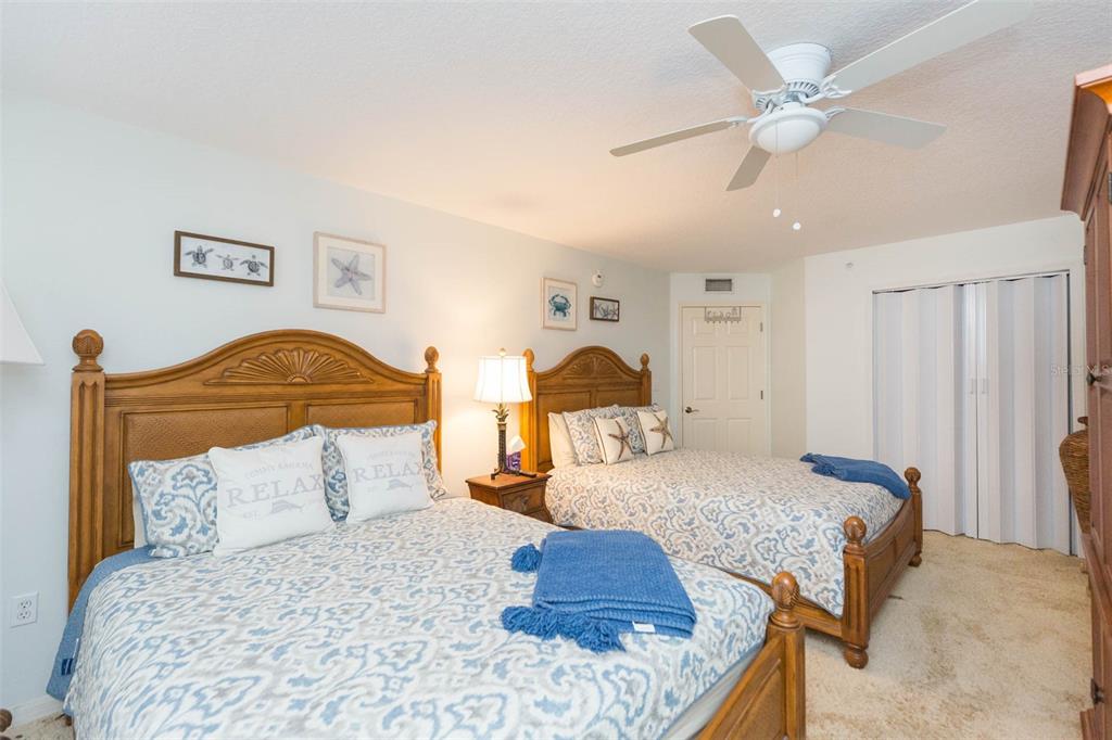 16326 Gulf Boulevard, Unit 109 Redington Beach, FL 33708 - Photo 26 of 63 a bedroom with a bed and a lamp