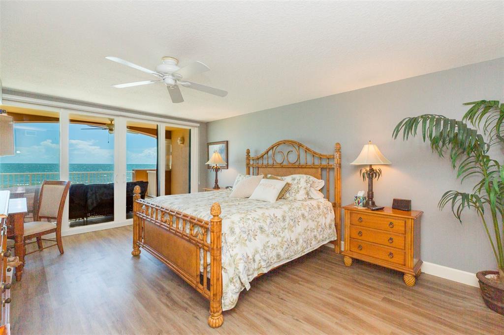 16326 Gulf Boulevard, Unit 109 Redington Beach, FL 33708 - Photo 30 of 63 a bedroom with a bed and wooden floor