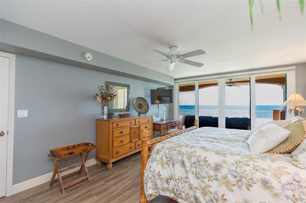16326 Gulf Boulevard, Unit 109 Redington Beach, FL 33708 - Photo 32 of 63 a bedroom with a bed and wooden floor