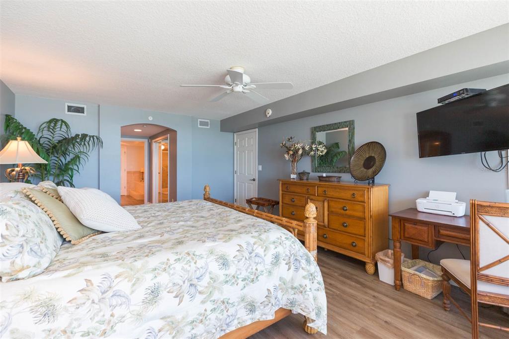 16326 Gulf Boulevard, Unit 109 Redington Beach, FL 33708 - Photo 34 of 63 a bedroom with a bed and a flat screen tv