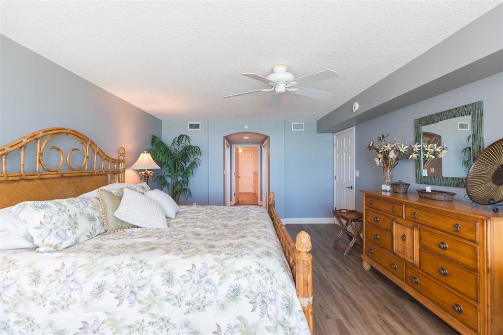 16326 Gulf Boulevard, Unit 109 Redington Beach, FL 33708 - Photo 35 of 63 a bedroom with a large bed and a chandelier