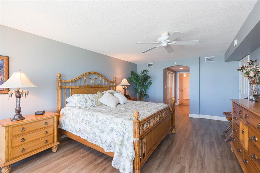 16326 Gulf Boulevard, Unit 109 Redington Beach, FL 33708 - Photo 36 of 63 a bedroom with a bed and a chandelier