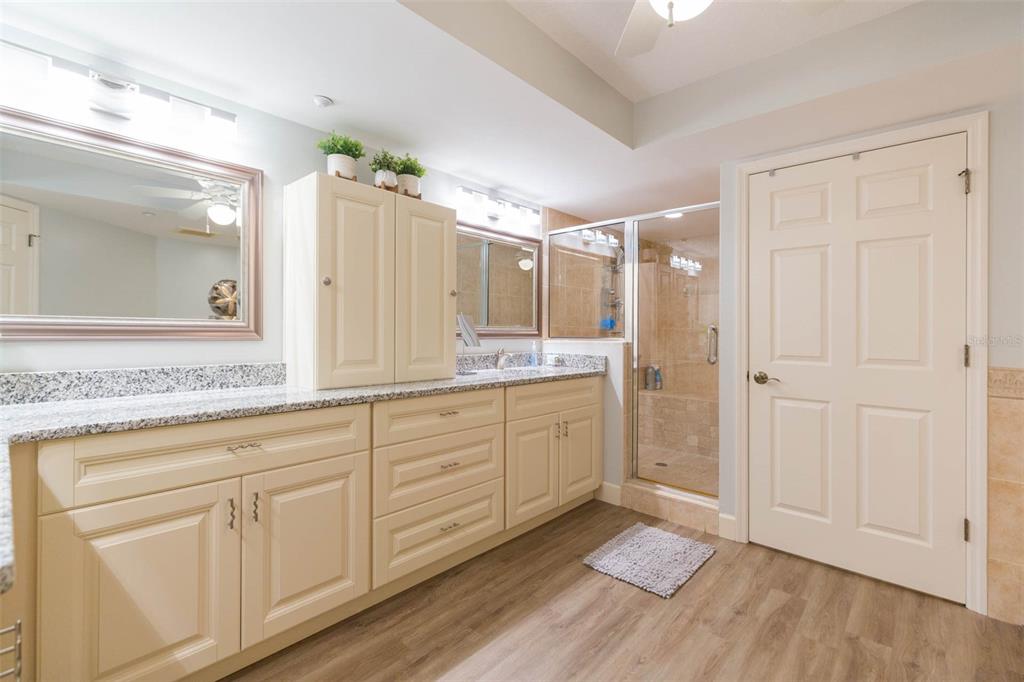 16326 Gulf Boulevard, Unit 109 Redington Beach, FL 33708 - Photo 37 of 63 a spacious bathroom with a granite countertop sink mirror and a