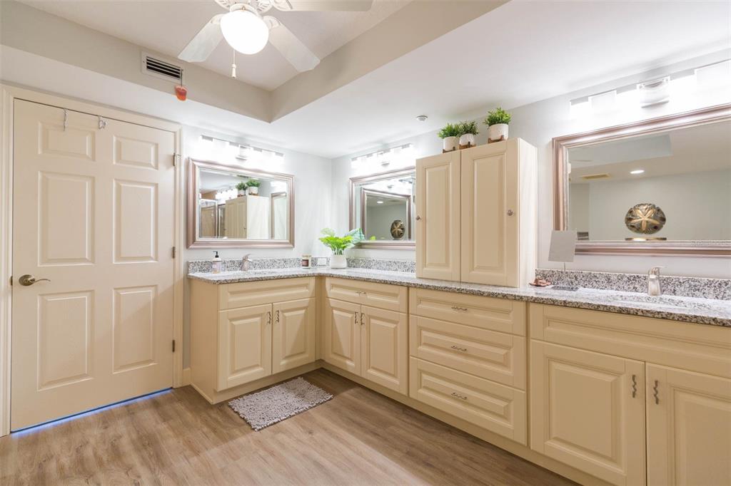 16326 Gulf Boulevard, Unit 109 Redington Beach, FL 33708 - Photo 38 of 63 a spacious bathroom with a granite countertop sink and a mirror
