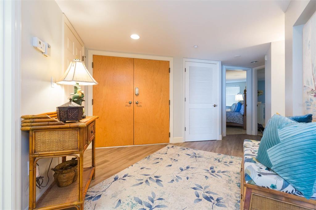 16326 Gulf Boulevard, Unit 109 Redington Beach, FL 33708 - Photo 4 of 63 a bedroom with a bed and a chandelier
