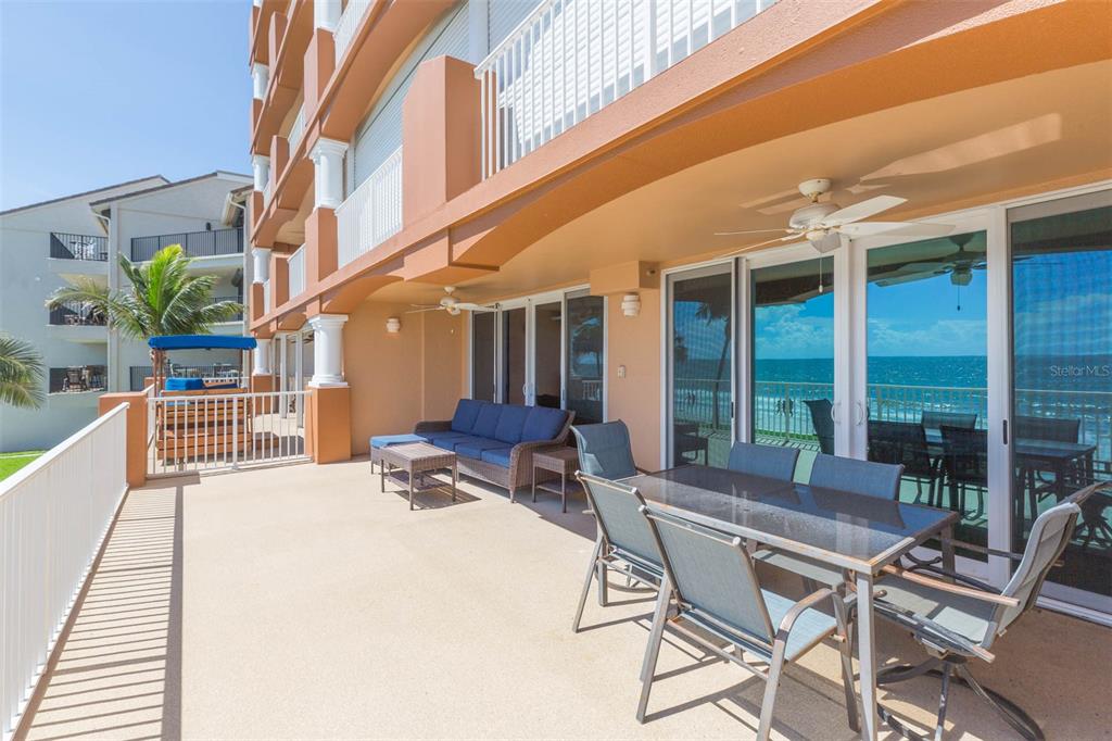 16326 Gulf Boulevard, Unit 109 Redington Beach, FL 33708 - Photo 43 of 63 a building outdoor space with patio furniture and potted plants