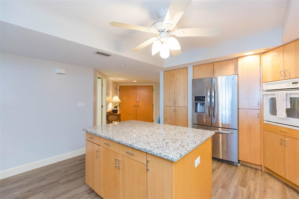 16326 Gulf Boulevard, Unit 109 Redington Beach, FL 33708 - Photo 9 of 63 a kitchen with granite countertop a sink cabinets and stainless steel appliances