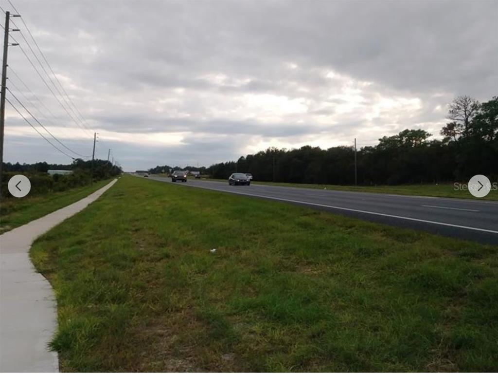 9468 Marengo Street Weeki Wachee, FL 34613 - Photo 7 of 8 a view of a golf course with a lake