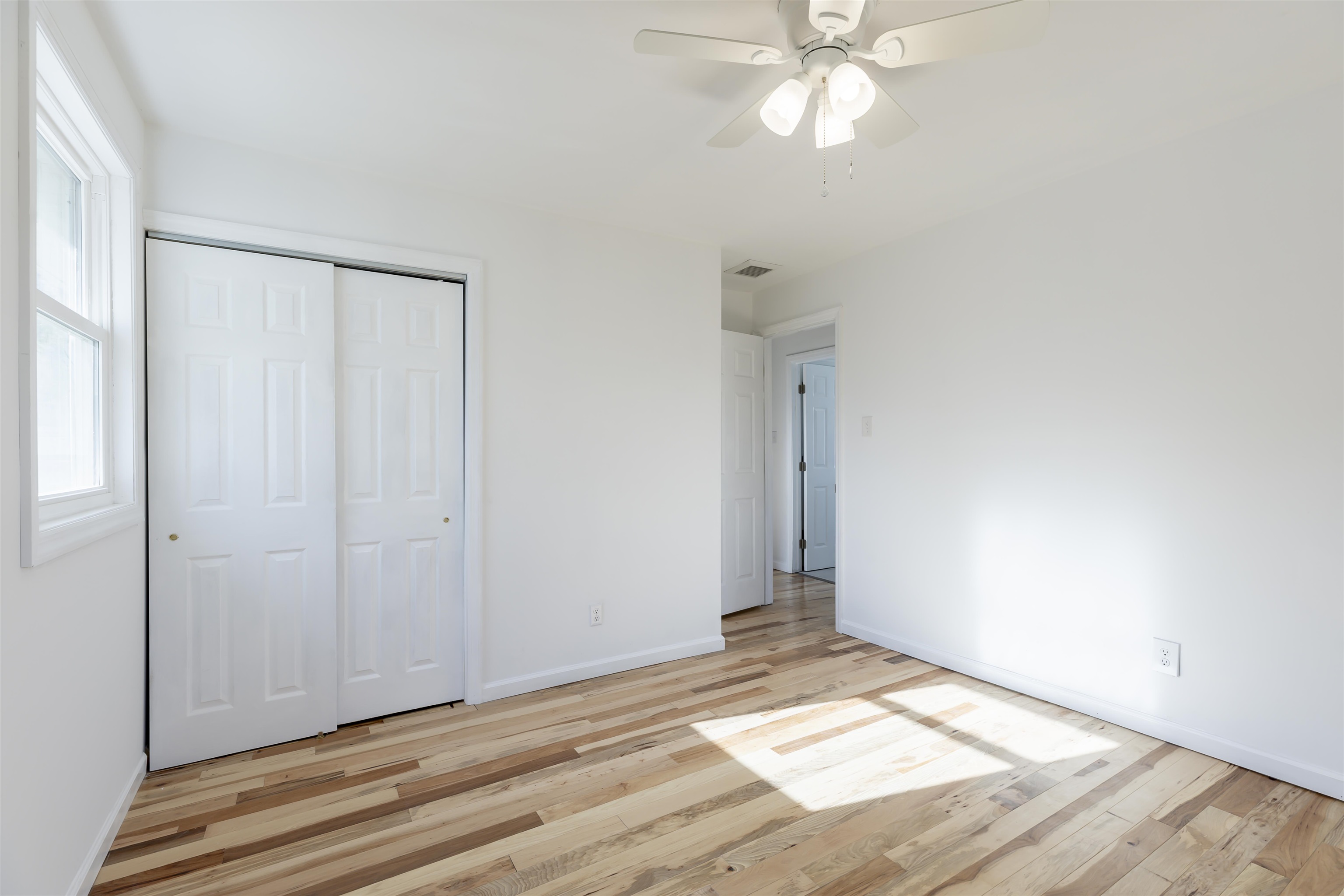116 Orchard Drive North Cape May, NJ 08204 - Photo 17 of 32 a view of an empty room with wooden floor and a window