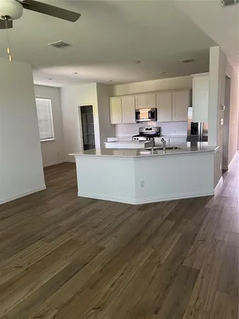 a view of kitchen and sink with wooden floor