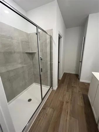 a bathroom with a glass shower door