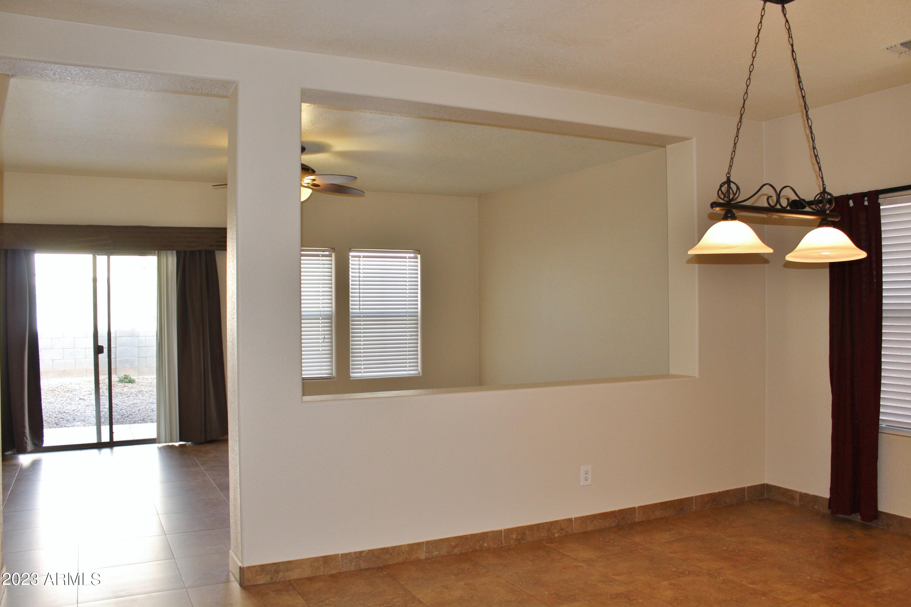 17278 North 184th Drive Surprise, AZ 85374 - Photo 11 of 32 a view of an empty room with a window and wooden floor