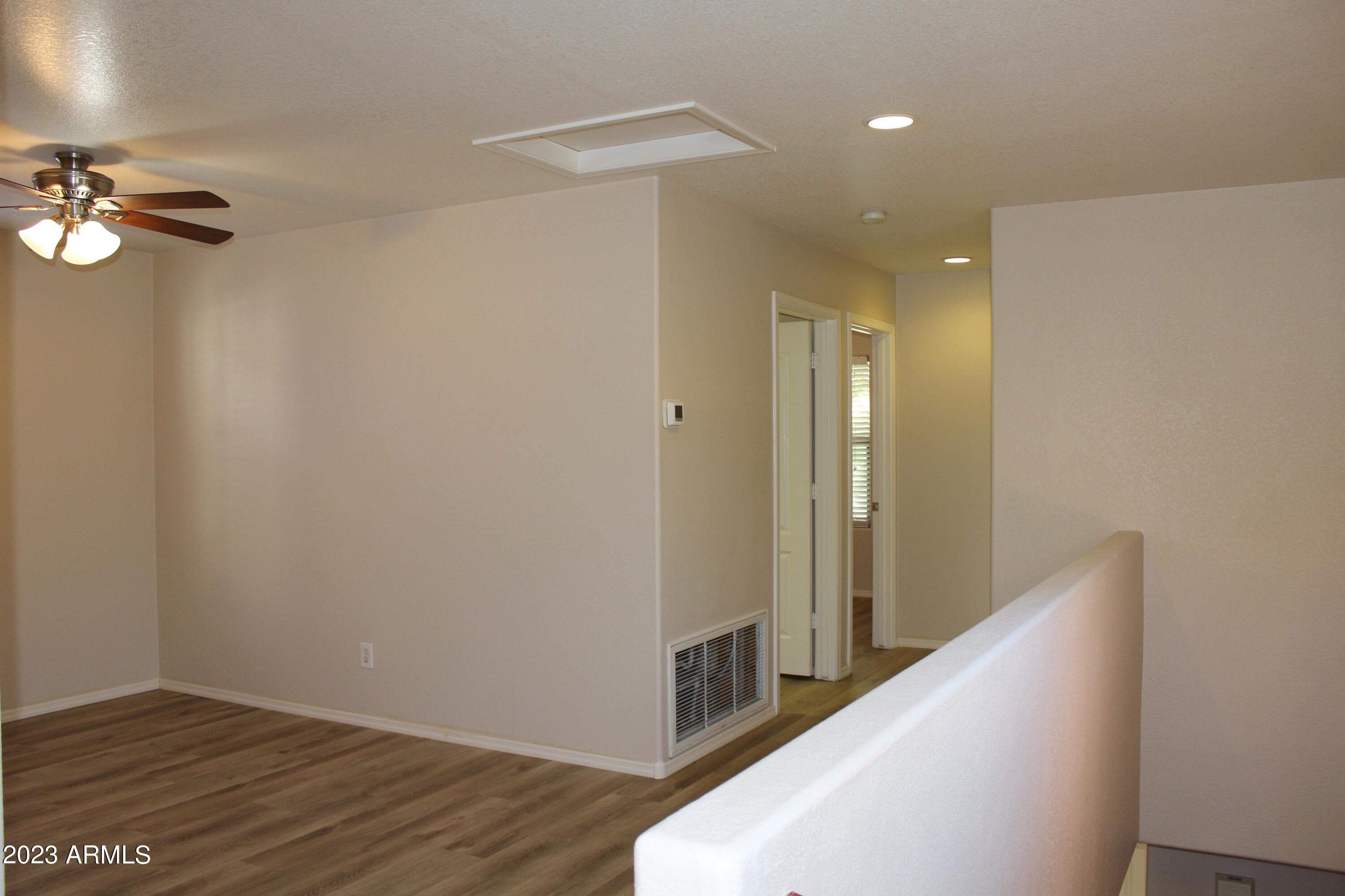 17278 North 184th Drive Surprise, AZ 85374 - Photo 15 of 32 a view of a hallway with wooden floor
