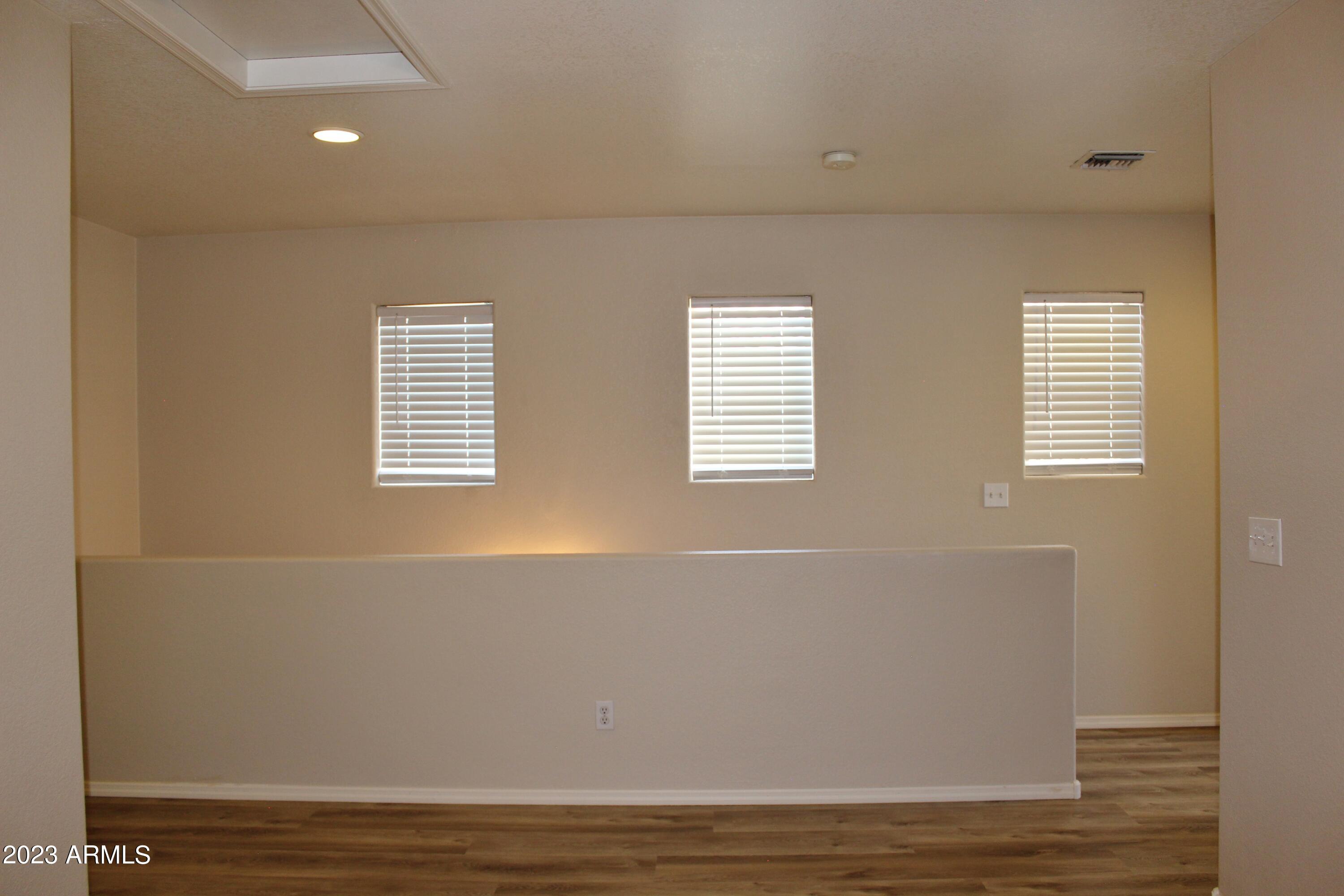 17278 North 184th Drive Surprise, AZ 85374 - Photo 17 of 32 a view of empty room with wooden floor and fan