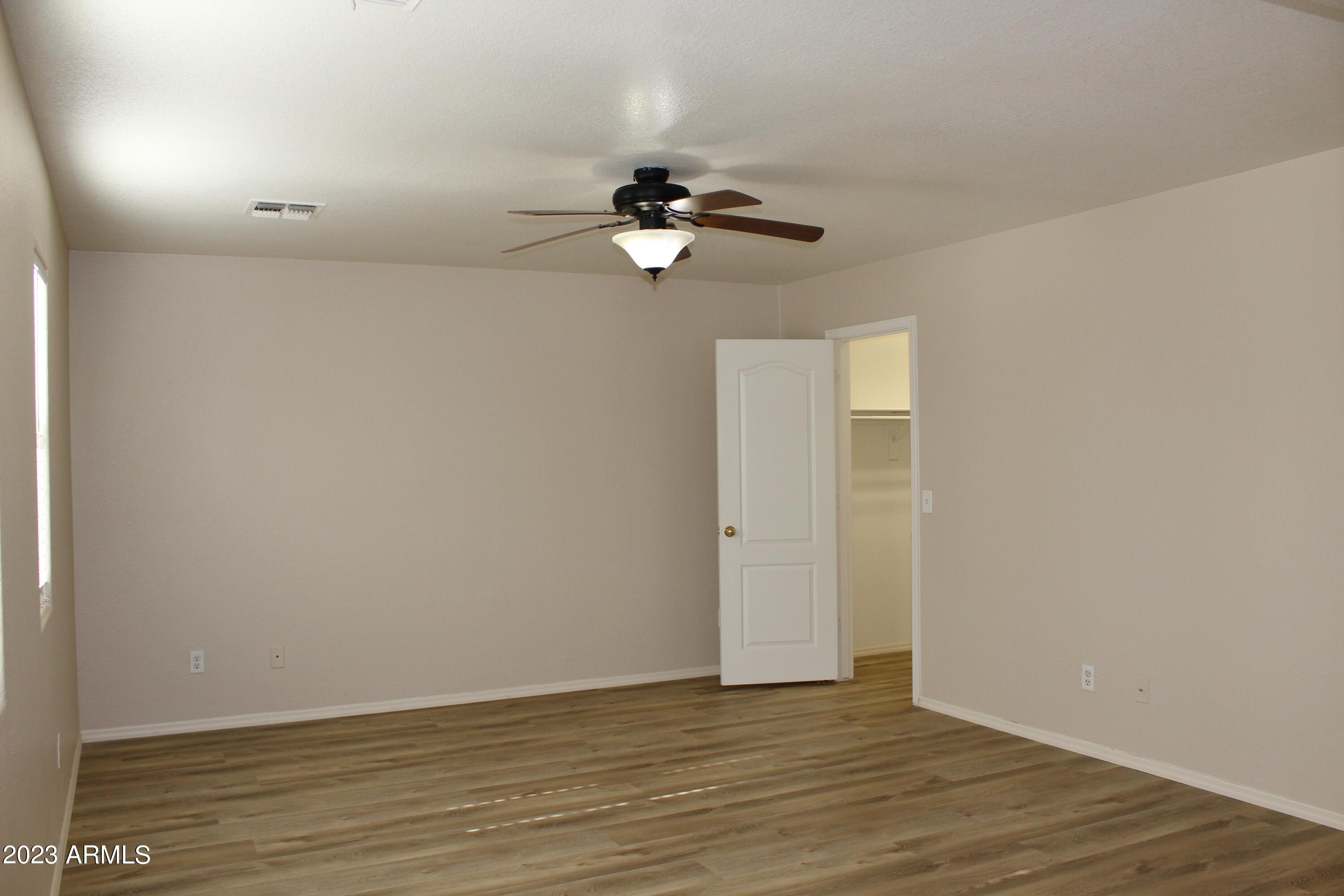17278 North 184th Drive Surprise, AZ 85374 - Photo 19 of 32 a view of an empty room with wooden floor