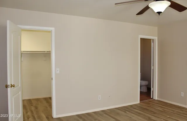 a view of a room with wooden floor and closet