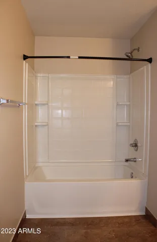 a bathroom with a shower and a bath tub