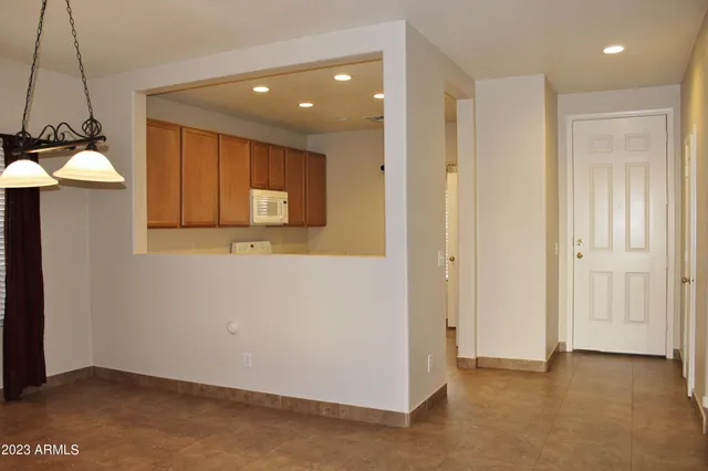 a view of a hallway with a chair and a table