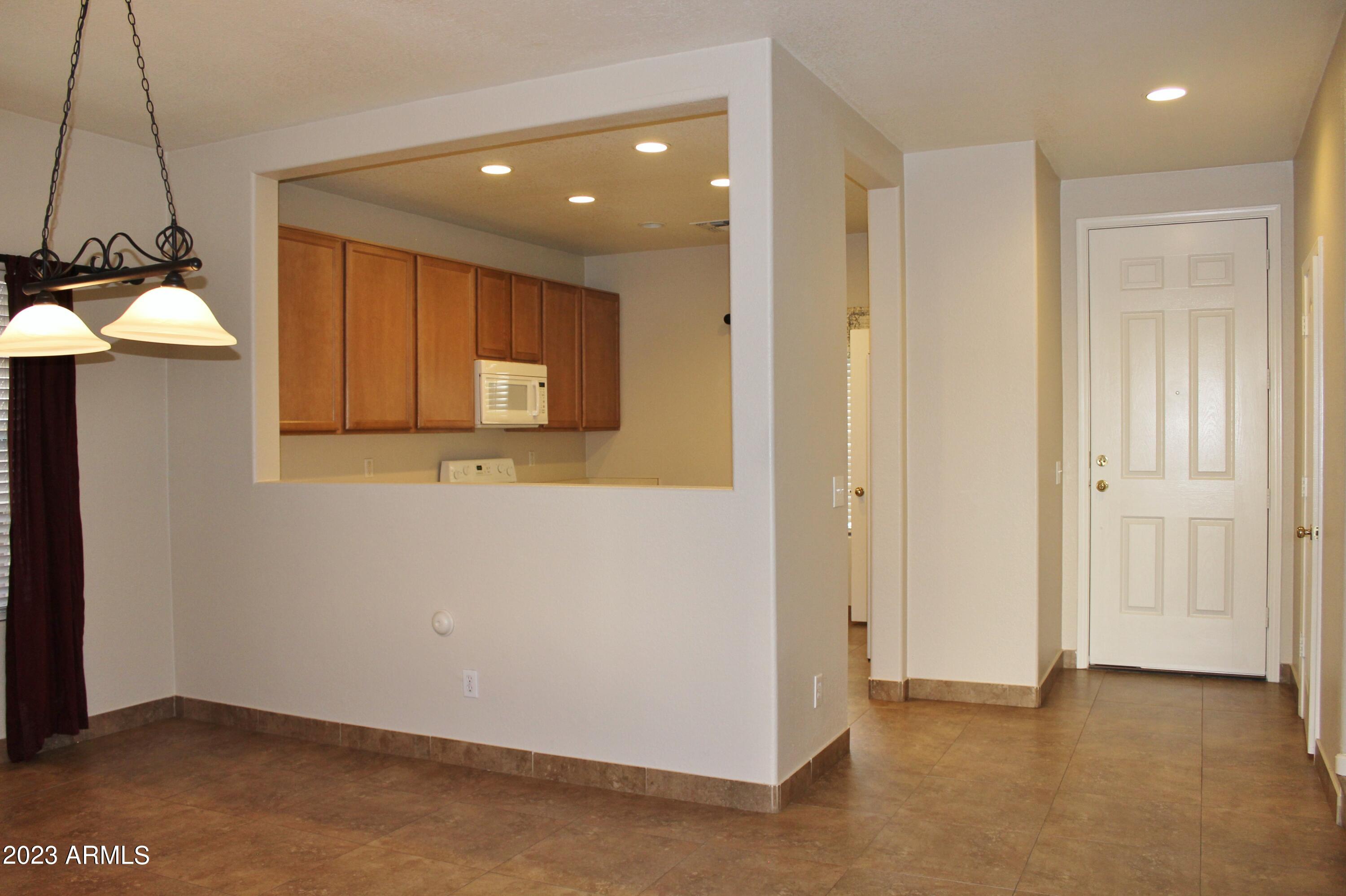 17278 North 184th Drive Surprise, AZ 85374 - Photo 4 of 32 a view of a hallway with a chair and a table
