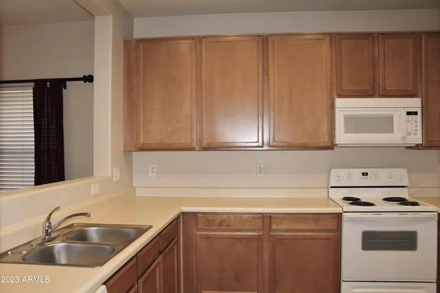 a kitchen with a sink cabinets and stainless steel appliances