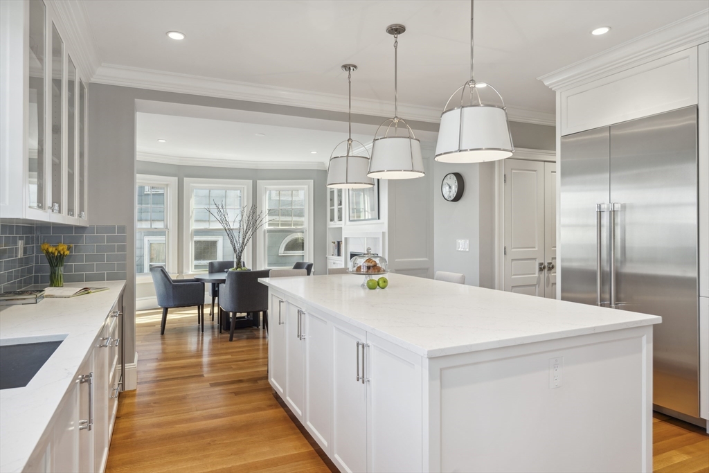 73 Upland Road Cambridge, MA 02140 - Photo 15 of 42 a large kitchen with kitchen island a large island in it