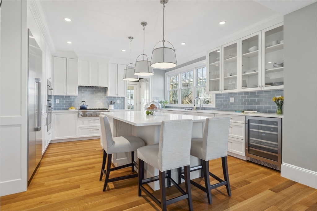 73 Upland Road Cambridge, MA 02140 - Photo 17 of 42 a kitchen with stainless steel appliances granite countertop a kitchen island a stove a table and chairs in it