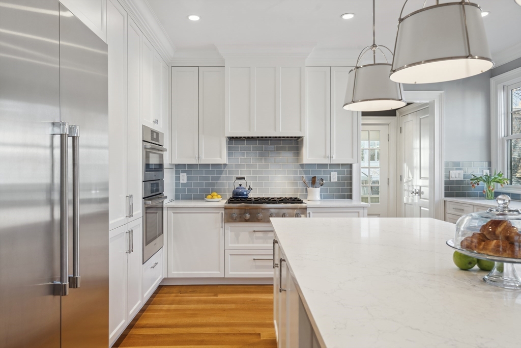 73 Upland Road Cambridge, MA 02140 - Photo 18 of 42 a kitchen with stainless steel appliances granite countertop a refrigerator a sink and a stove