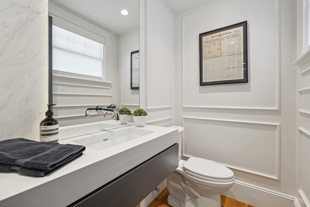 73 Upland Road Cambridge, MA 02140 - Photo 19 of 42 a bathroom with a sink a toilet and mirror