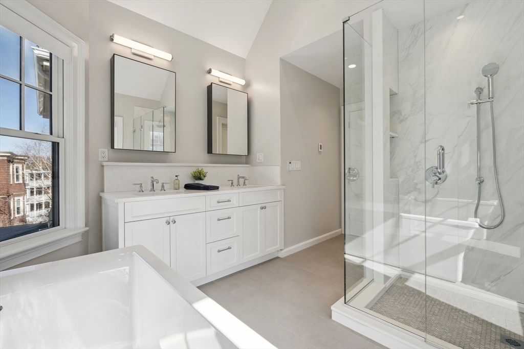 73 Upland Road Cambridge, MA 02140 - Photo 25 of 42 a spacious bathroom with a shower sink and mirror