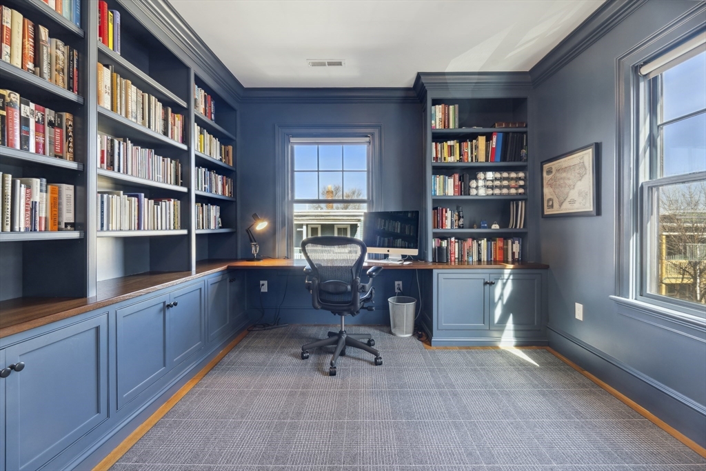 73 Upland Road Cambridge, MA 02140 - Photo 30 of 42 a view of a workspace with bookshelf and a window