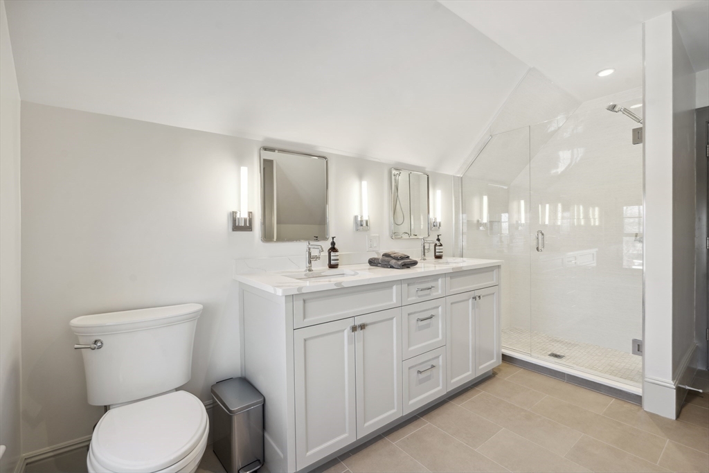 73 Upland Road Cambridge, MA 02140 - Photo 32 of 42 a bathroom with a toilet a sink a mirror and a shower