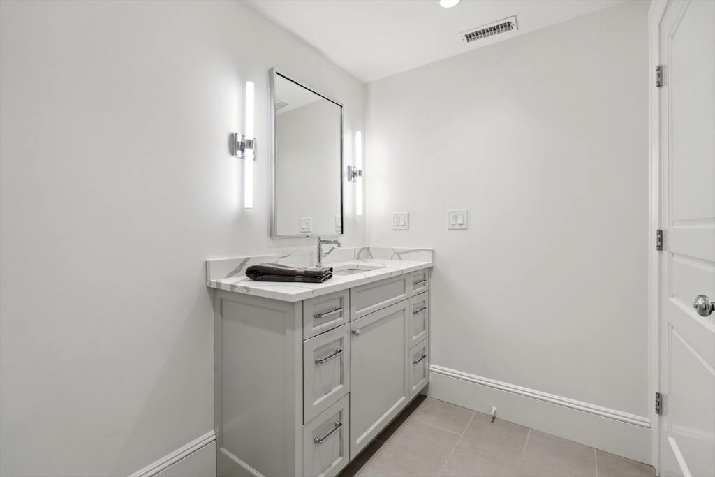 73 Upland Road Cambridge, MA 02140 - Photo 35 of 42 a bathroom with a sink and a mirror