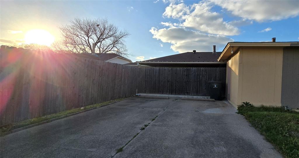 2224 Limestone Lane Garland, TX 75040 - Photo 16 of 16 a backyard of a house with lots of green space and wooden fence