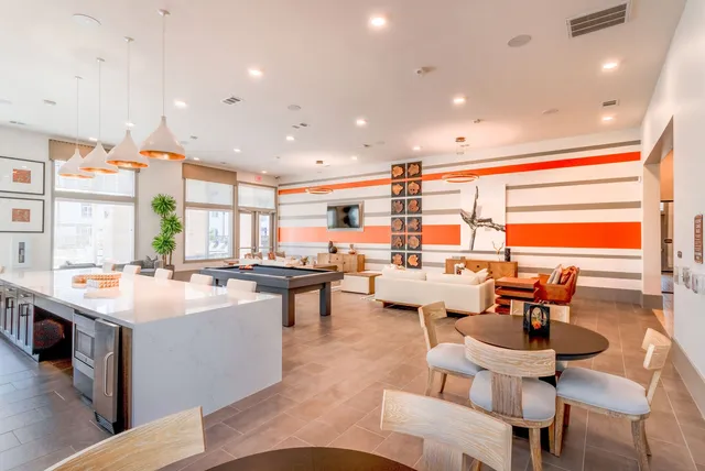 a large kitchen with a table and chairs