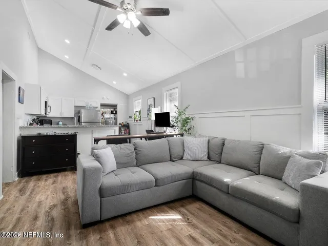 a living room with furniture and kitchen view