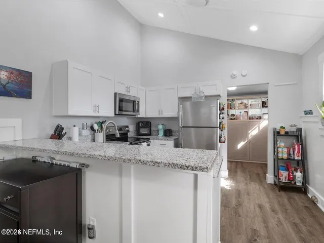 a kitchen with stainless steel appliances granite countertop a refrigerator stove a sink and a microwave