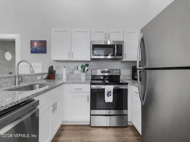 a view of living room with granite countertop furniture and a flat screen tv