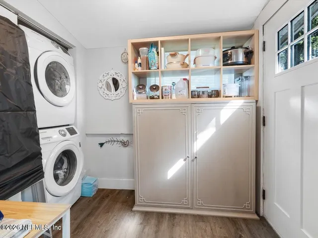 a view of a backyard with large trees and plants