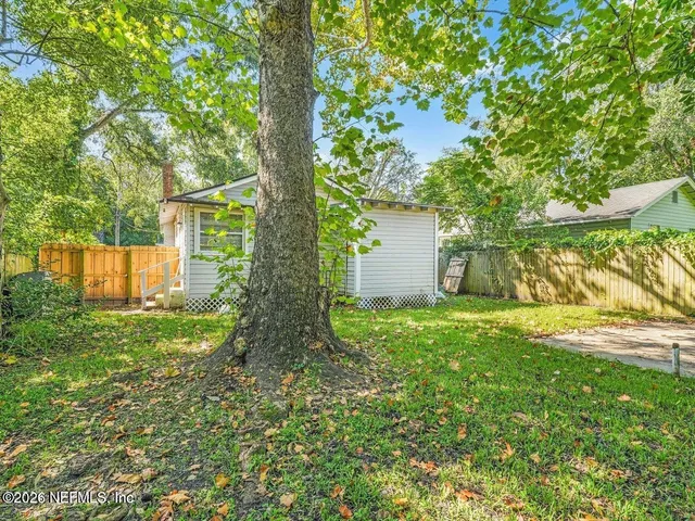 a view of a yard with a tree