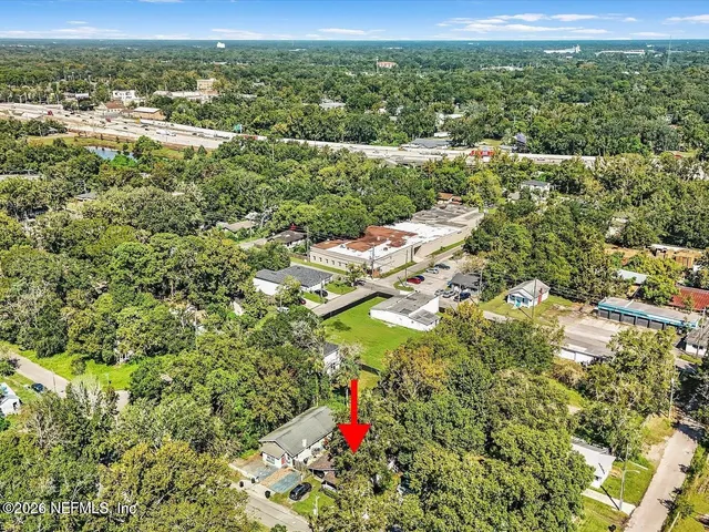 an aerial view of residential houses with city view