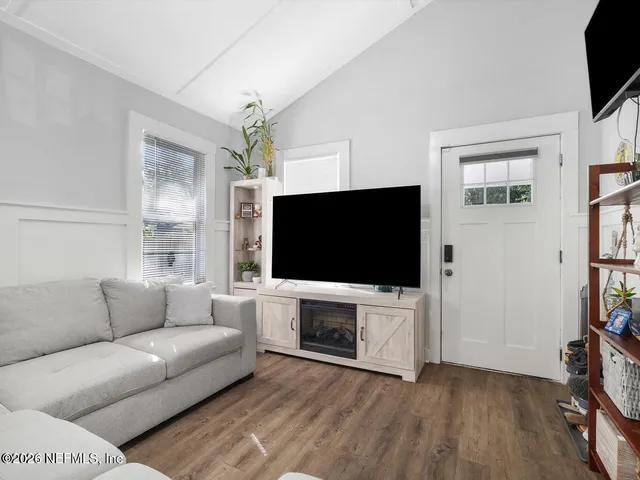a living room with furniture and a flat screen tv