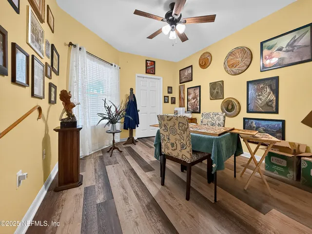 a view of a dining room with furniture and a chandelier