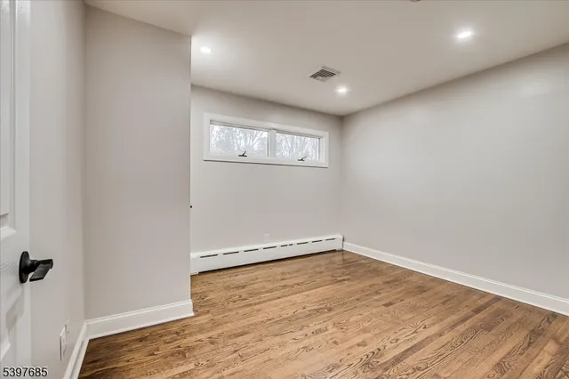 a view of a room with wooden floor
