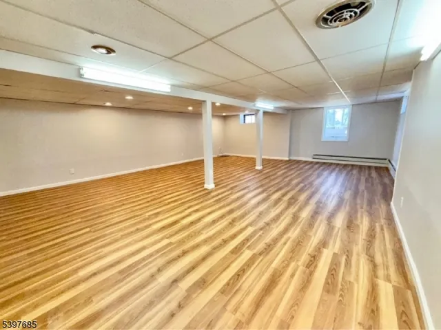 a view of an empty room with wooden floor