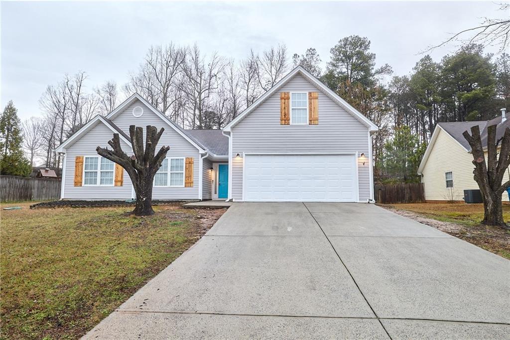 1645 Fort Mason Way Dacula, GA 30019 - Photo 1 of 28 a front view of a house with a yard and garage