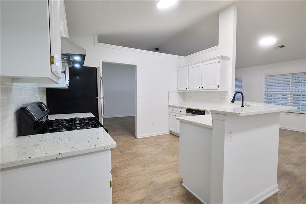 1645 Fort Mason Way Dacula, GA 30019 - Photo 11 of 28 a kitchen with a sink stove and refrigerator